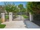 Elegant gated entrance with stone pillars adds security and curb appeal to the property at 2225 Johnson Ferry Rd., Marietta, GA 30062