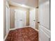 Hallway with wood flooring, three doors, and white trim at 2225 Johnson Ferry Rd., Marietta, GA 30062