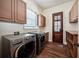 Laundry room with modern washer and dryer, utility sink, cabinets and wood-look flooring at 2225 Johnson Ferry Rd., Marietta, GA 30062