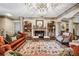 Elegant living room featuring a decorative ceiling, fireplace, custom built-ins, and hardwood floors at 2225 Johnson Ferry Rd., Marietta, GA 30062