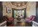 Elegant living room featuring hardwood floors, stylish furniture, and a bay window with beautiful curtains at 2225 Johnson Ferry Rd., Marietta, GA 30062