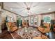 Cozy living room with hardwood floors, a unique light fixture, ample windows, and stylish furnishings at 2225 Johnson Ferry Rd., Marietta, GA 30062