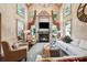 Inviting living room with high ceilings, a cozy fireplace, and large windows offering natural light at 2225 Johnson Ferry Rd., Marietta, GA 30062