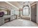 Elegant bathroom featuring double vanities, a glass shower, a soaking tub, and bright natural light at 2225 Johnson Ferry Rd., Marietta, GA 30062