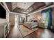 Spacious main bedroom with hardwood floors, tray ceilings, a ceiling fan, and a cozy rug at 2225 Johnson Ferry Rd., Marietta, GA 30062