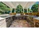 Outdoor kitchen featuring a built-in grill, stone countertops, stainless steel appliances at 2225 Johnson Ferry Rd., Marietta, GA 30062