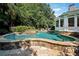 Beautiful in-ground pool with rock accents and outdoor seating, perfect for relaxing and entertaining at 2225 Johnson Ferry Rd., Marietta, GA 30062