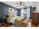 This bedroom showcases a ceiling fan, hardwood floors and a large window at 2230 Cheshire Bridge Ne Rd # 116, Atlanta, GA 30324