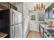 Bright kitchen shows stainless refrigerator and white exterior door with natural light at 2230 Cheshire Bridge Ne Rd # 116, Atlanta, GA 30324