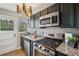 Well lit kitchen featuring stainless appliances, stone countertops and modern fixtures at 2230 Cheshire Bridge Ne Rd # 116, Atlanta, GA 30324