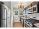 Well-lit kitchen featuring stainless steel appliances, granite countertops, and a tiled backsplash at 2230 Cheshire Bridge Ne Rd # 116, Atlanta, GA 30324