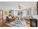 Bright living room with hardwood floors, ceiling fan, large window, and comfortable leather couch at 2230 Cheshire Bridge Ne Rd # 116, Atlanta, GA 30324