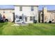Spacious backyard featuring green lawn, patio, and exterior of home with windows and door for outdoor enjoyment at 3641 Oakleaf Pass, Fairburn, GA 30213