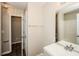 Bright bathroom with a modern vanity, framed mirror, and a doorway that leads to a closet for extra storage at 3641 Oakleaf Pass, Fairburn, GA 30213