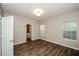 Comfortable bedroom features hardwood floors, natural light, and an ensuite bathroom at 3641 Oakleaf Pass, Fairburn, GA 30213