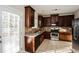 Well-equipped kitchen features stainless steel appliances, dark cabinetry, and tile backsplash at 3641 Oakleaf Pass, Fairburn, GA 30213