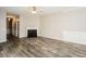 Spacious living room boasts stylish hardwood floors, a cozy fireplace, and modern light fixtures at 3641 Oakleaf Pass, Fairburn, GA 30213