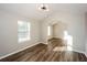 Open living room features elegant wood floors, vaulted ceilings, and decorative lighting at 3641 Oakleaf Pass, Fairburn, GA 30213