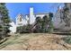 Home's rear exterior shows a backyard with trees and a deck with a staircase at 1301 Dayspring Trce, Lawrenceville, GA 30045