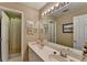 Bathroom with double sink vanity, neutral walls, decorative mirror and a shower/tub at 1301 Dayspring Trce, Lawrenceville, GA 30045