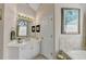 Bright bathroom features a tub, large mirror, vanity with sink, and an arched window at 1301 Dayspring Trce, Lawrenceville, GA 30045