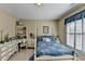 Bedroom featuring a bed and desk with large window providing plenty of natural light at 1301 Dayspring Trce, Lawrenceville, GA 30045