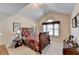 Comfortable bedroom features a vaulted ceiling, arched window, and ample space for relaxation at 1301 Dayspring Trce, Lawrenceville, GA 30045