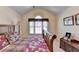 Comfortable bedroom features a vaulted ceiling, arched window, and space for relaxation at 1301 Dayspring Trce, Lawrenceville, GA 30045