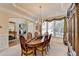 Elegant dining room with a chandelier, wood table, and a view of the entryway at 1301 Dayspring Trce, Lawrenceville, GA 30045