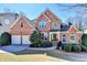 Beautiful two-story brick house with a landscaped yard and a welcoming entrance at 1301 Dayspring Trce, Lawrenceville, GA 30045