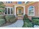 Close-up of the front entrance showing a walkway and neatly trimmed hedges at 1301 Dayspring Trce, Lawrenceville, GA 30045