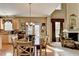 Well-lit eat-in kitchen offering hardwood floors, light wood cabinets, and seamless flow to living area at 1301 Dayspring Trce, Lawrenceville, GA 30045