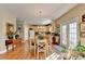Bright eat-in kitchen boasts hardwood floors, light wood cabinetry, and French door to outdoor space at 1301 Dayspring Trce, Lawrenceville, GA 30045