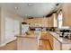 Well-lit kitchen with granite countertops, an island, and stainless steel appliances at 1301 Dayspring Trce, Lawrenceville, GA 30045