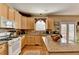 Charming kitchen with hardwood floors, light wood cabinets, and center island at 1301 Dayspring Trce, Lawrenceville, GA 30045