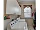 Practical laundry room with washer, dryer, overhead cabinets, and a window at 1301 Dayspring Trce, Lawrenceville, GA 30045