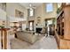Open-concept living room featuring a fireplace, high ceilings, and a view of the kitchen at 1301 Dayspring Trce, Lawrenceville, GA 30045