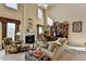 Cozy living room with a fireplace, tall windows, and comfortable seating arrangements at 1301 Dayspring Trce, Lawrenceville, GA 30045