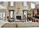 Inviting living room with a fireplace, tall windows, and comfortable seating arrangement at 1301 Dayspring Trce, Lawrenceville, GA 30045