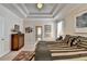 Spacious main bedroom with tray ceilings and an en-suite bathroom in view at 1301 Dayspring Trce, Lawrenceville, GA 30045