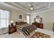 Tranquil main bedroom boasts tray ceilings, soft lighting, and neutral color palette at 1301 Dayspring Trce, Lawrenceville, GA 30045