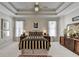 Main bedroom featuring tray ceilings, plush carpeting, and decorative furnishings at 1301 Dayspring Trce, Lawrenceville, GA 30045