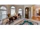 Relaxing sitting area with classic furniture, arched windows, and natural light at 1301 Dayspring Trce, Lawrenceville, GA 30045
