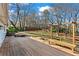 Large backyard featuring a wooden deck with bench seating and mature trees at 1760 Canton Hills Cir, Marietta, GA 30062