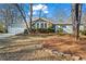 Charming home with a two-car garage and lush landscaping, complemented by a stone accent wall and mature trees at 1760 Canton Hills Cir, Marietta, GA 30062