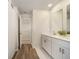 Inviting bathroom with dual vanity, sleek cabinetry, and a tiled floor, blending functionality with modern style at 1761 Dosk Ave, Lawrenceville, GA 30044