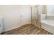 Stylishly appointed bathroom boasting wood-look floors, a separate tub, and a glass shower at 1761 Dosk Ave, Lawrenceville, GA 30044