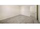 Comfortable bedroom with neutral carpeting, a door and a glimpse into an adjacent room at 1761 Dosk Ave, Lawrenceville, GA 30044