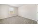Cozy bedroom with a window, neutral-toned walls, and soft carpeting, offering a blank canvas for personalization at 1761 Dosk Ave, Lawrenceville, GA 30044