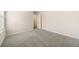 Comfortable bedroom with neutral carpeting, a door and a glimpse into an adjacent room at 1761 Dosk Ave, Lawrenceville, GA 30044